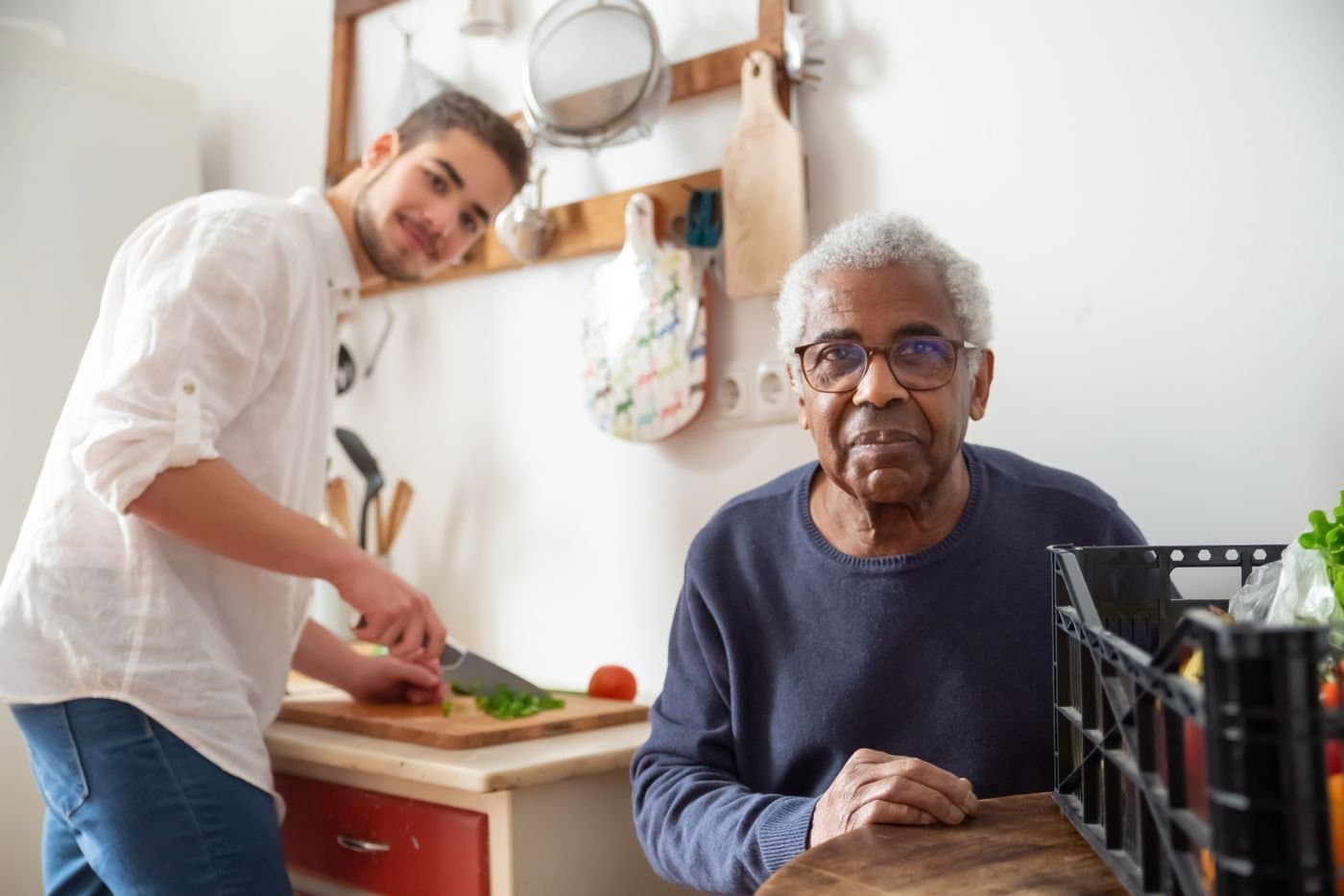 Family members talking together while preparing food in a bright kitchen