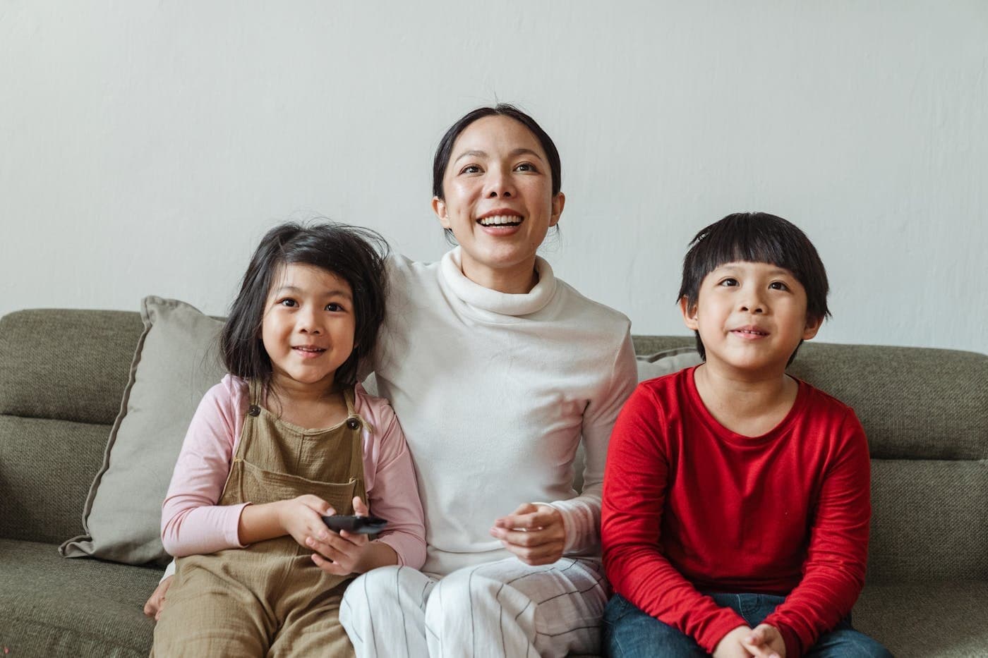Mother relaxing on the sofa with her children at home