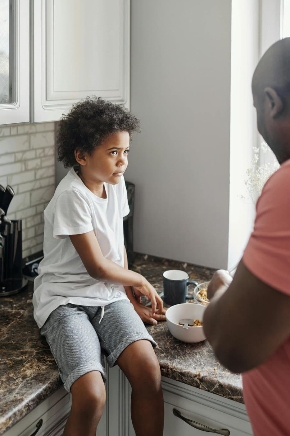Father and son sharing breakfast together at the kitchen counter
