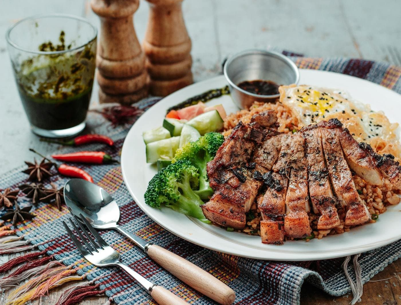 Homemade meal with rice, vegetables, and grilled meat on a family plate