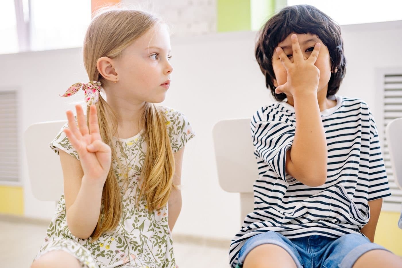 Children practicing counting together in a bright classroom