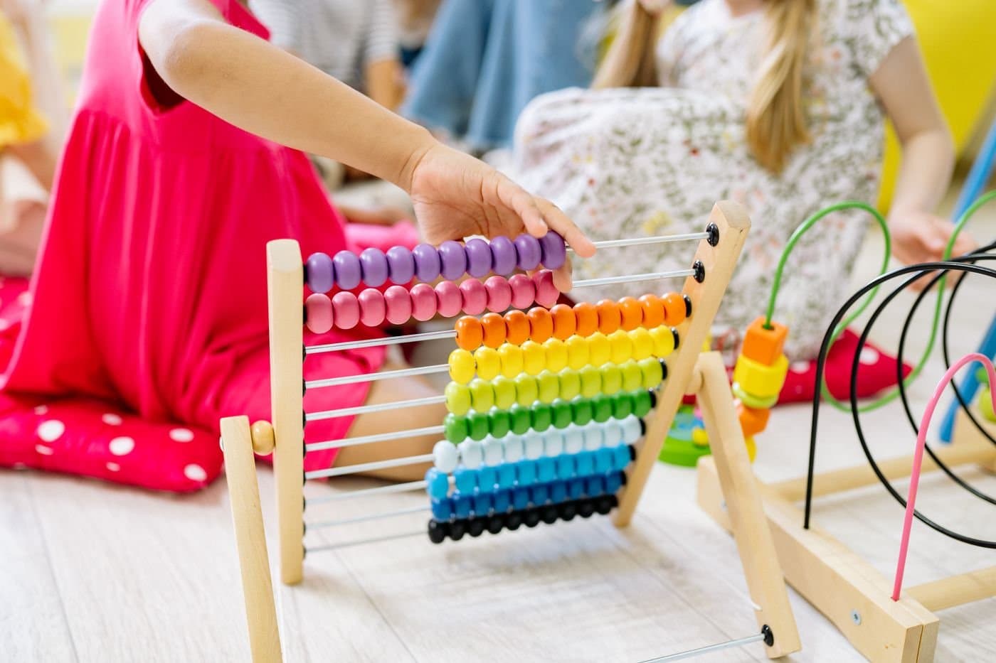 Child learning to count on a colorful abacus during playtime