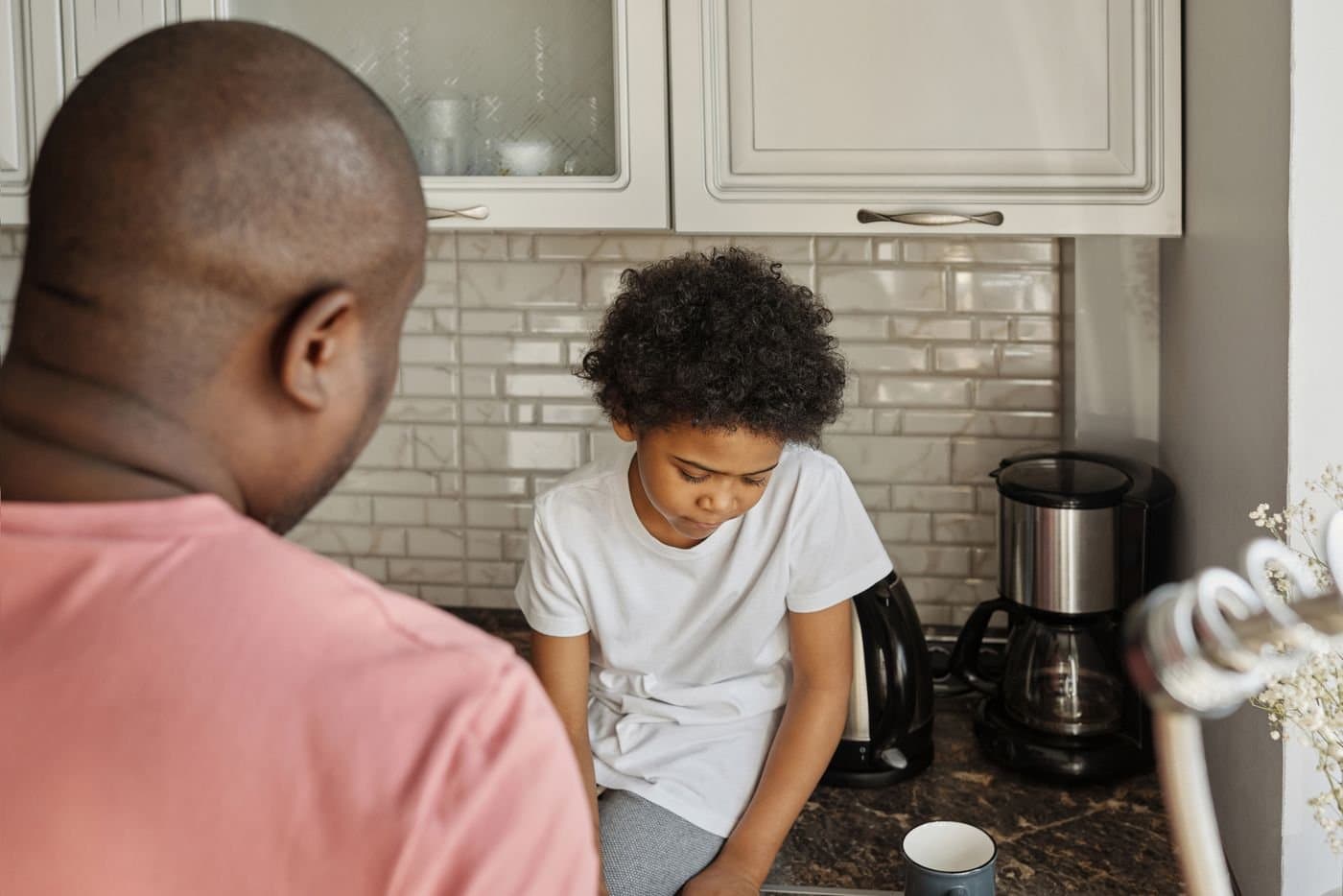 Father talking with his child during a quiet moment in the kitchen