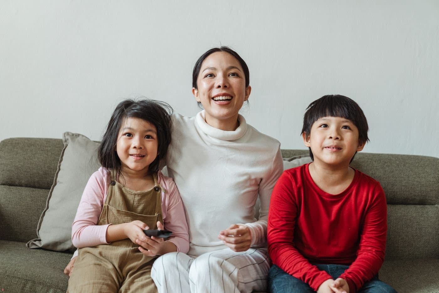 Mother relaxing on the sofa with her children at home