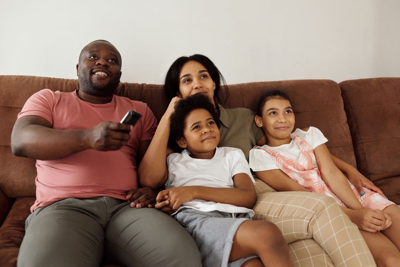 Parents and children relaxing together on the sofa at home