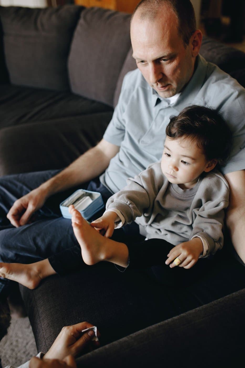Father gently caring for his toddler at home