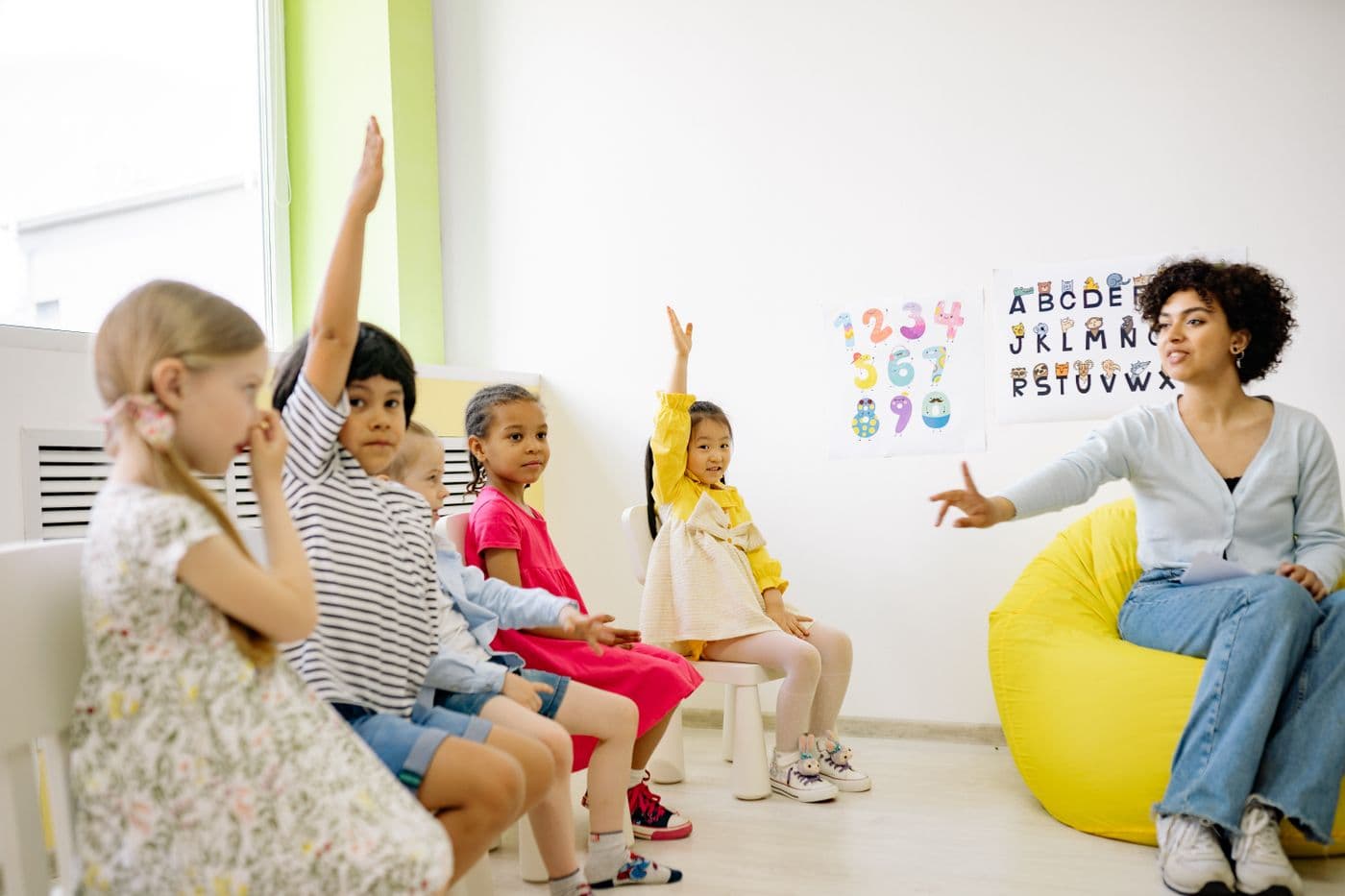 School-age children learning together with a teacher in a bright classroom