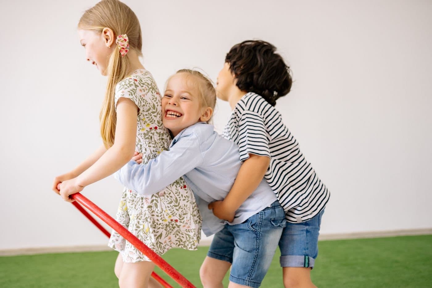 Children laughing and playing together in a bright indoor play space