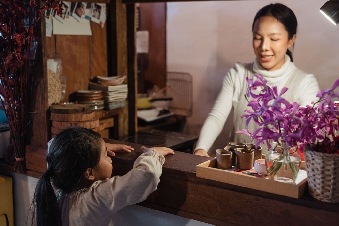 Ethnic mother and teenage daughter talking together in a home kitchen