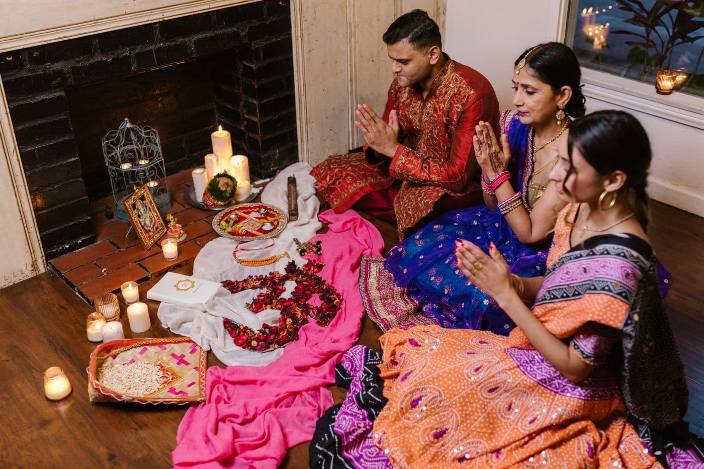 South Asian extended family gathered at home for a traditional ceremony together