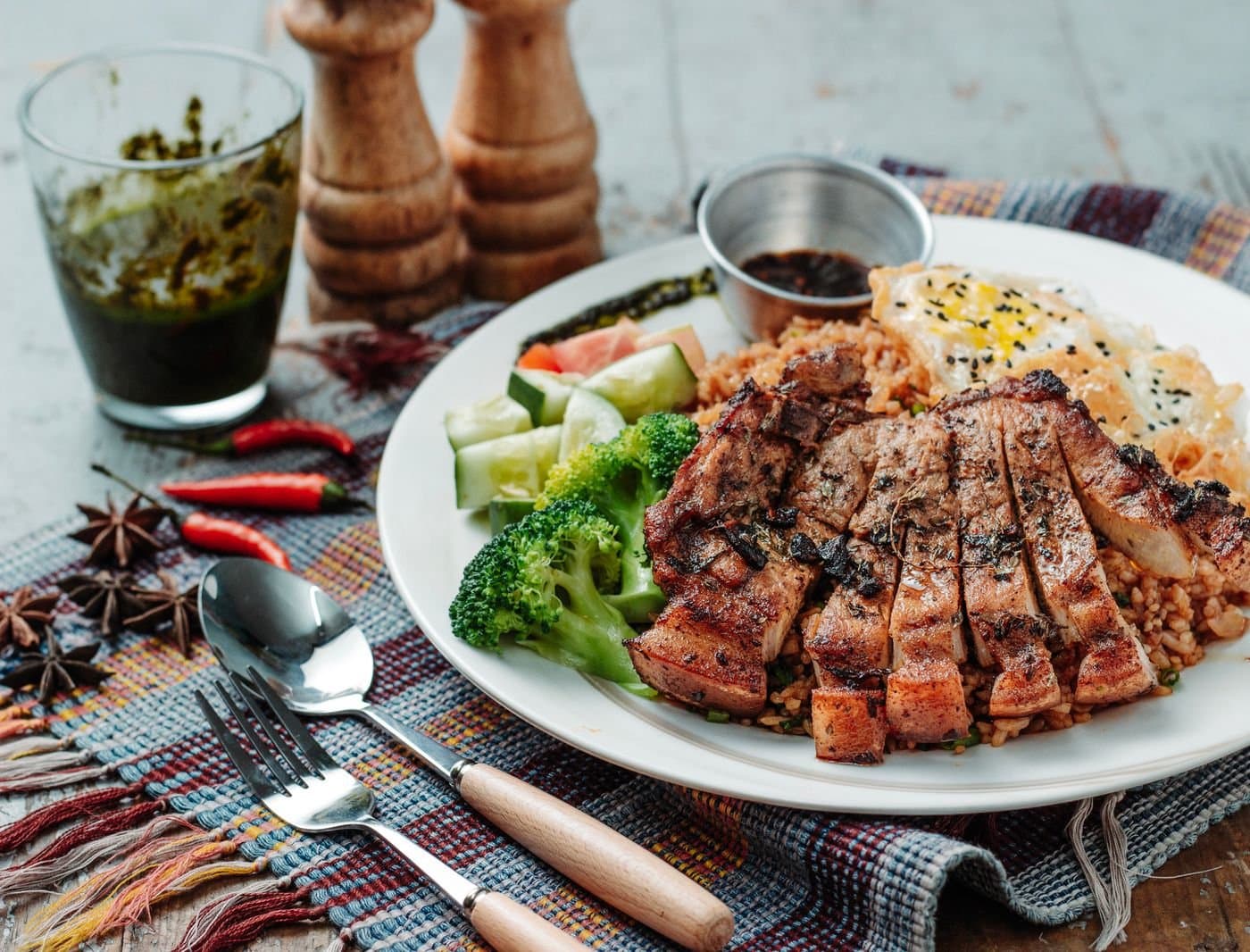 Homemade meal with rice, vegetables, and grilled meat on a family plate