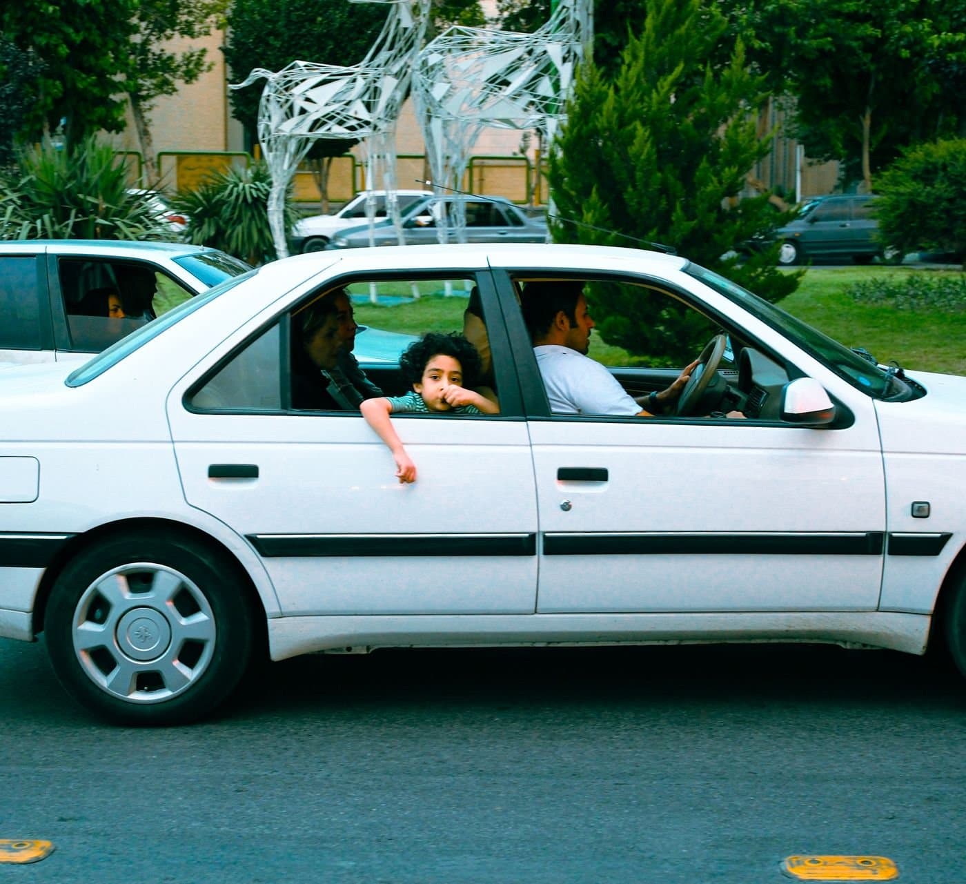 Family with a young child on a road trip together in a car