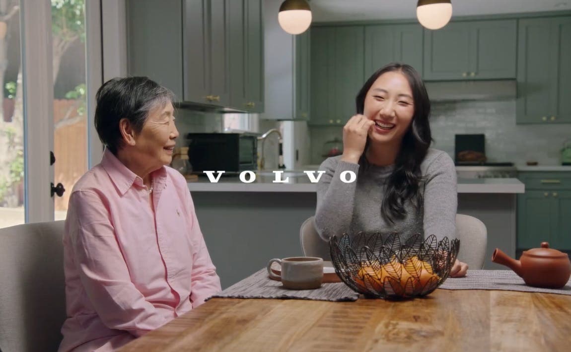 Chinese Canadian comedian Andrea Jin laughing with her grandmother at a kitchen table