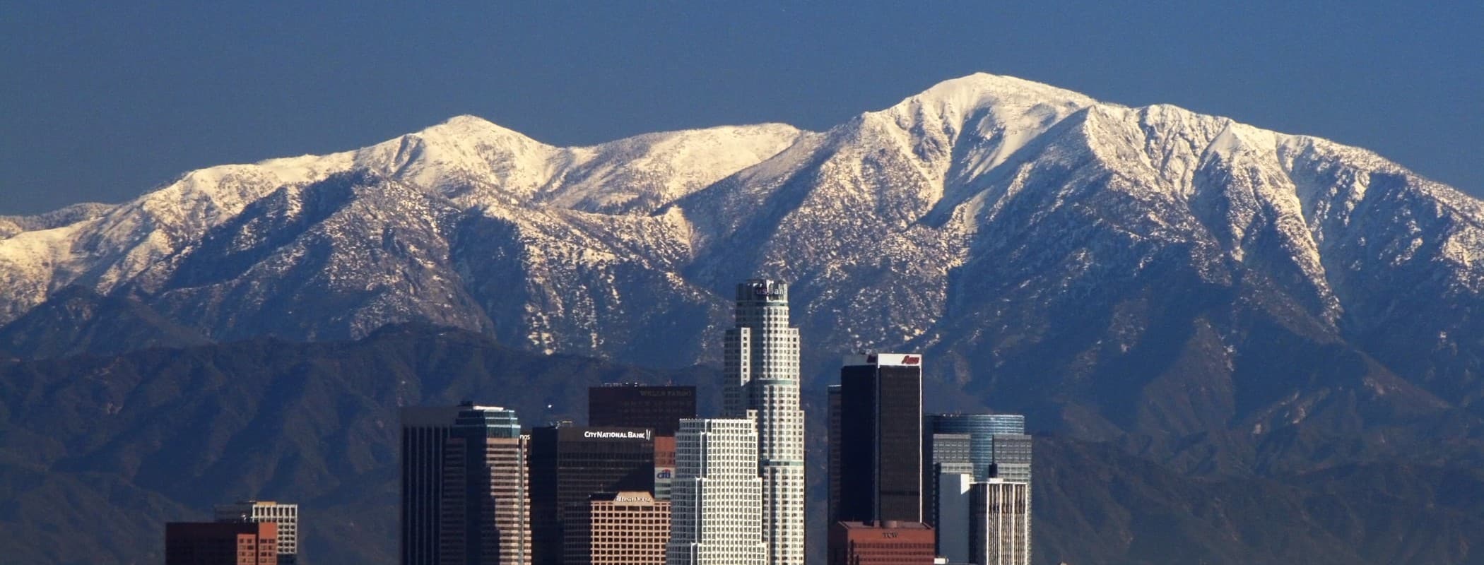 Downtown Los Angeles skyline with the snow-covered San Gabriel Mountains behind it