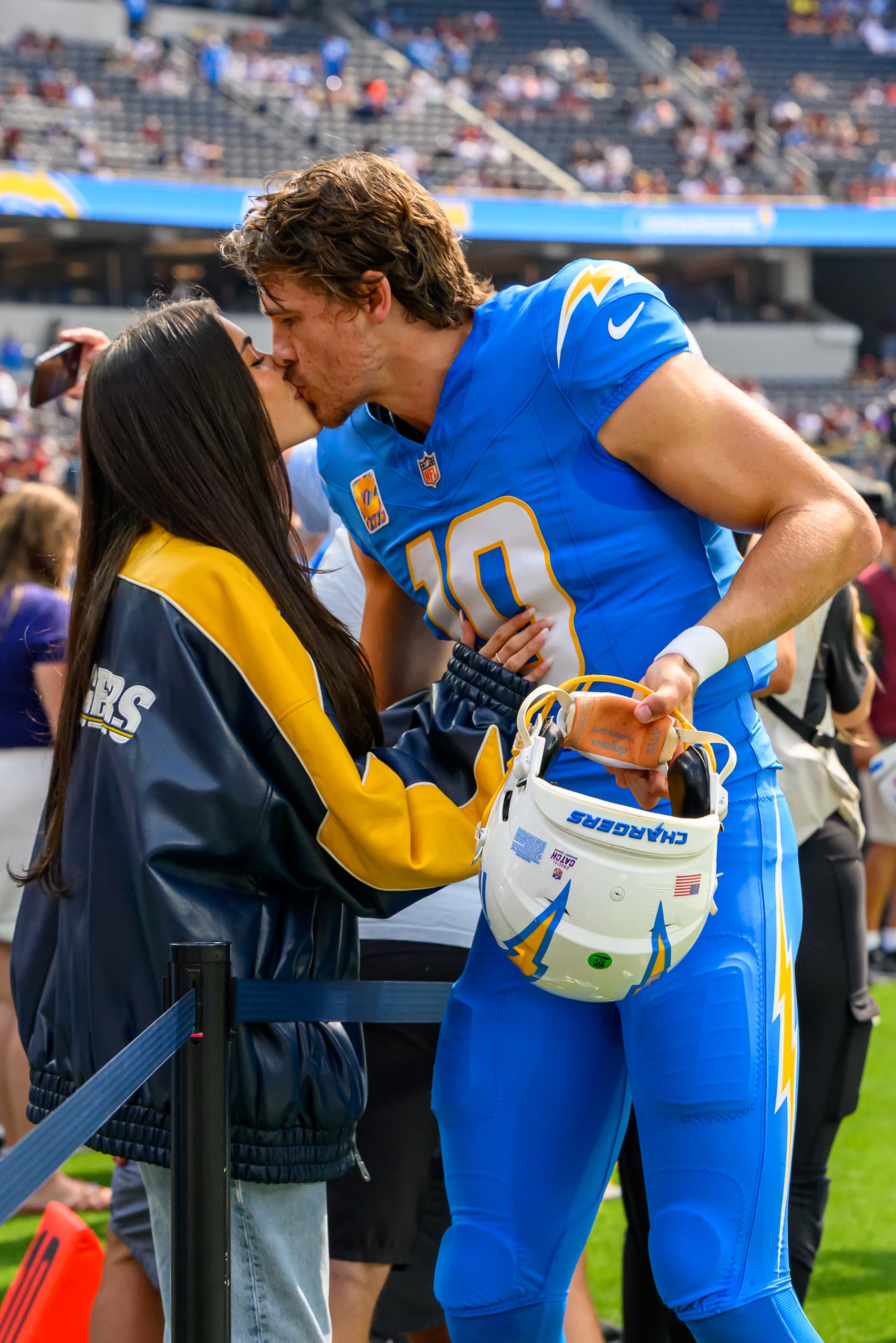 Madison Beer and Justin Herbert together on the Chargers sideline at SoFi Stadium in October 2025