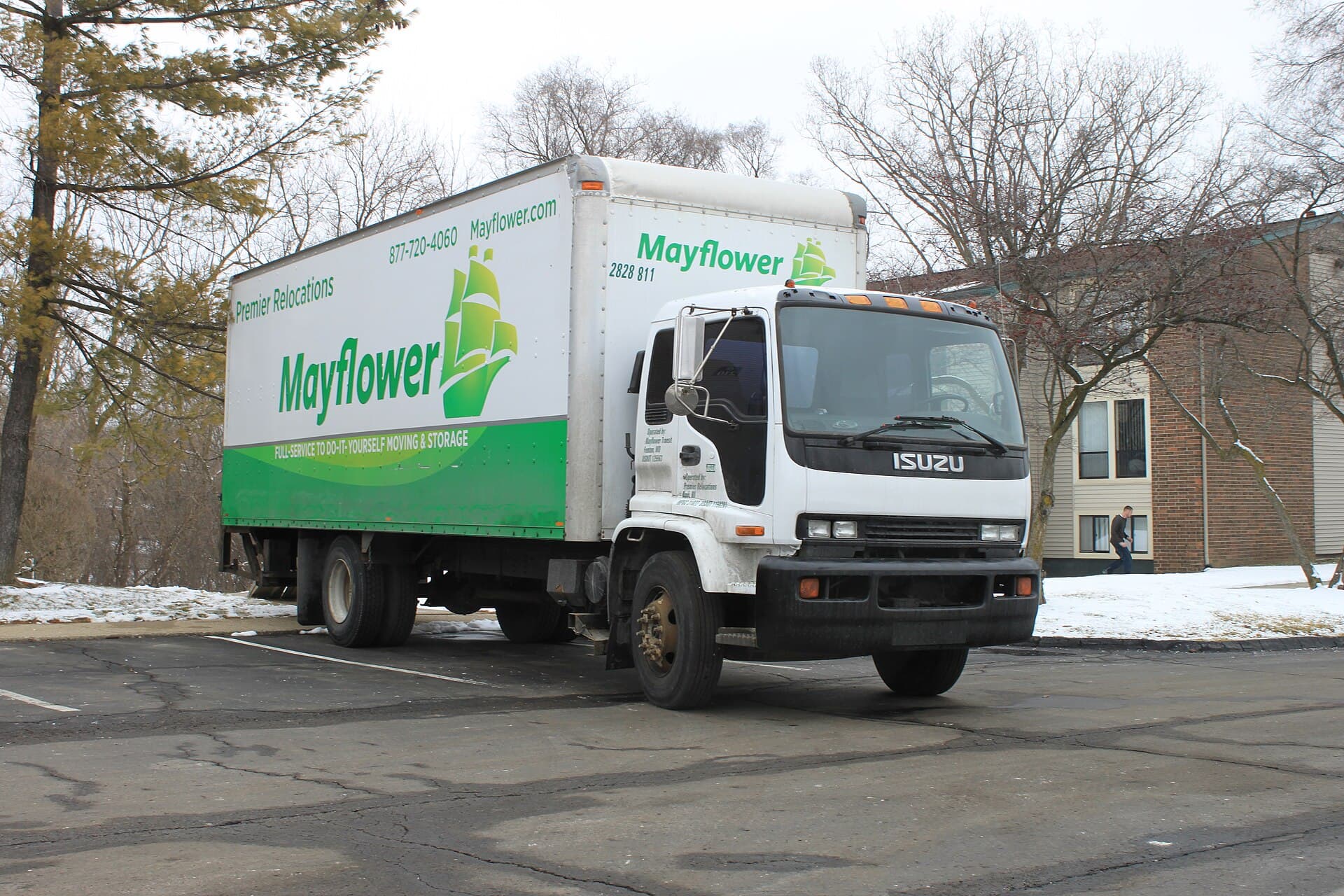 A moving truck parked outside an apartment complex, ready for a household move