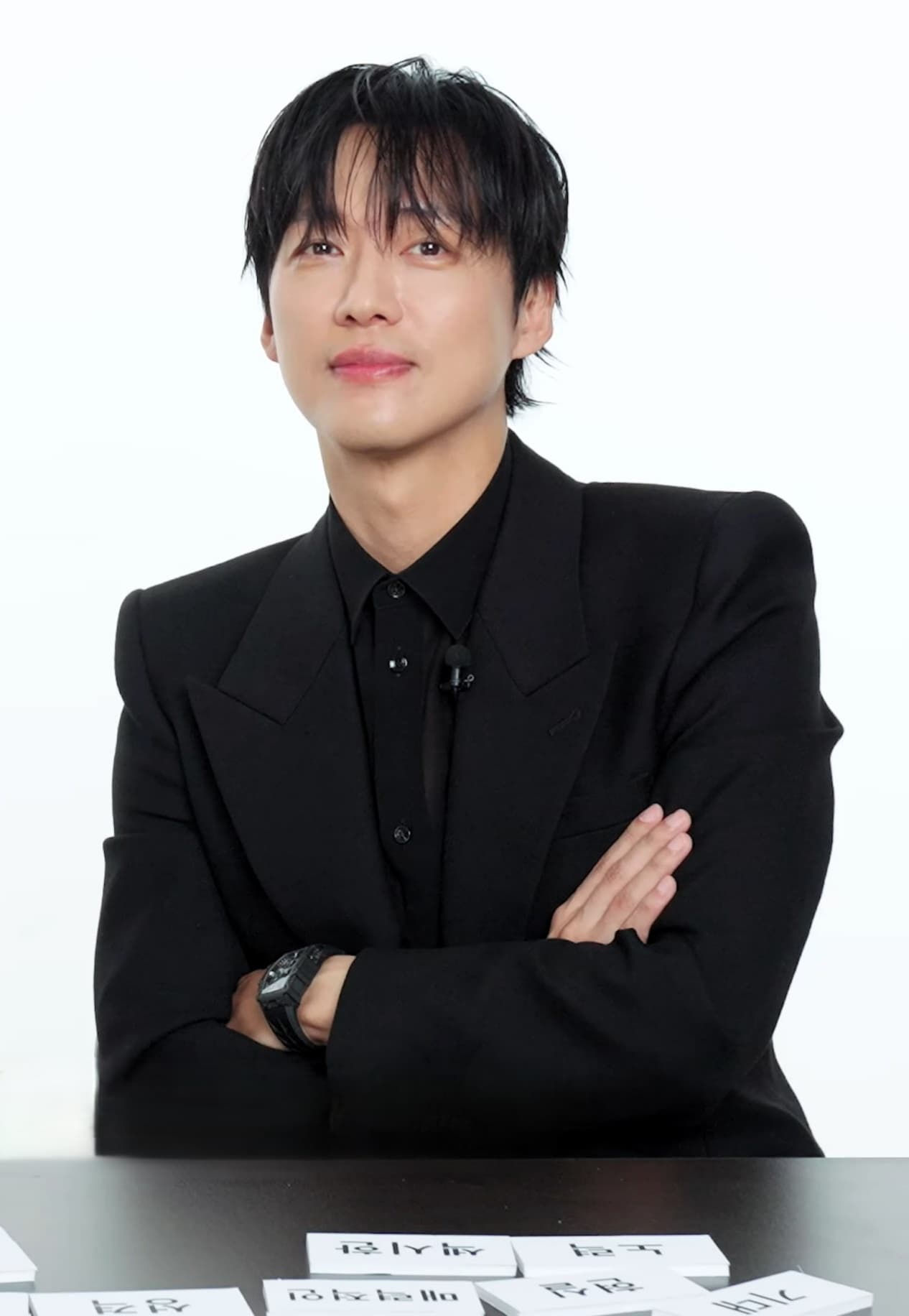 South Korean actor Namkoong Min in a dark suit looking toward camera during a 2025 Marie Claire Korea film promo
