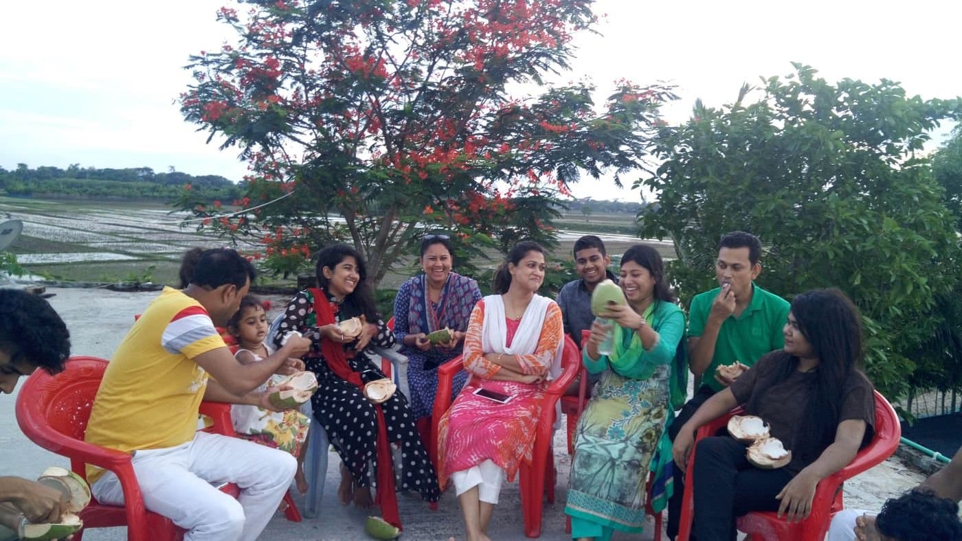 Multigenerational family sharing food together outdoors