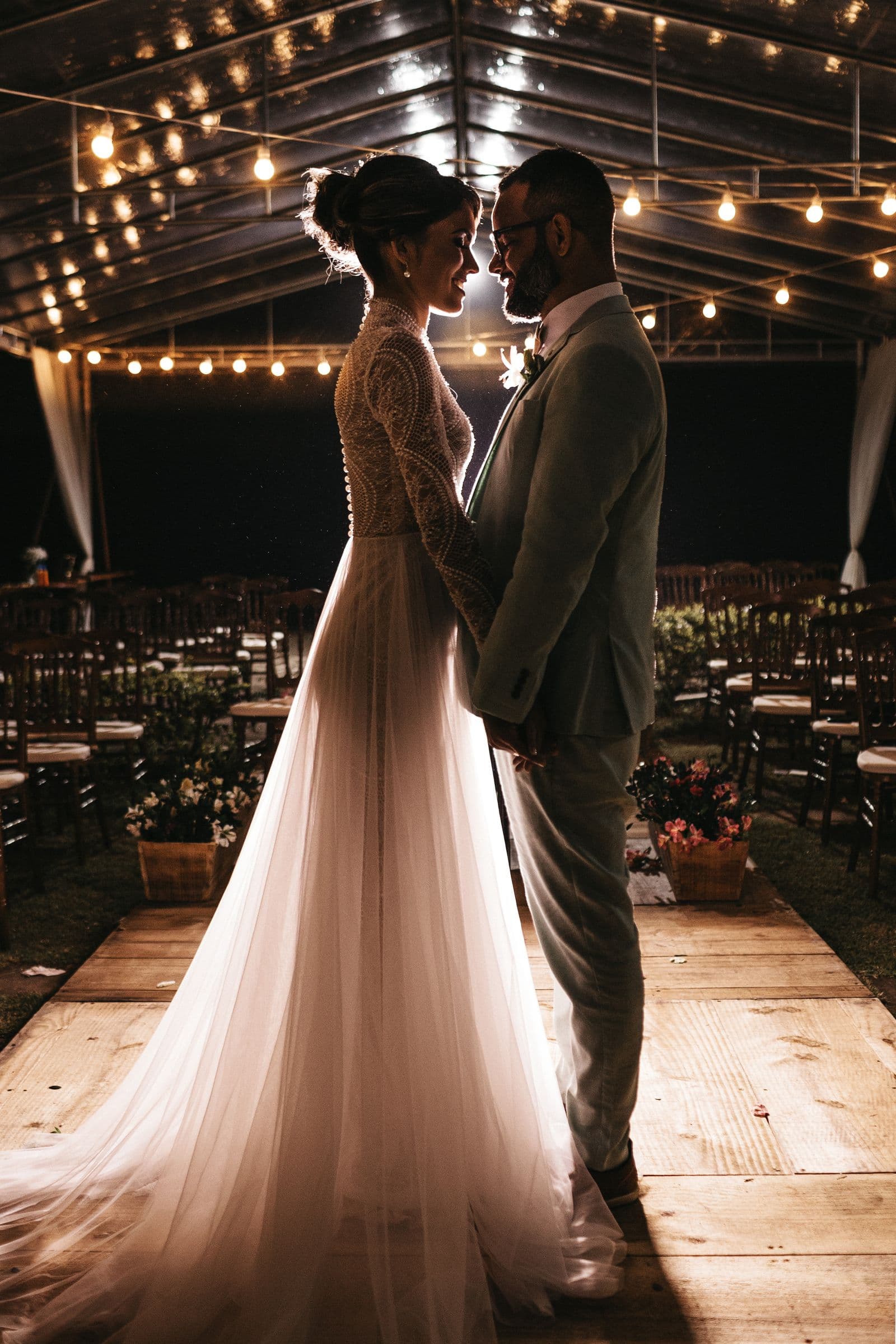 Newlywed couple sharing a quiet moment under warm lights