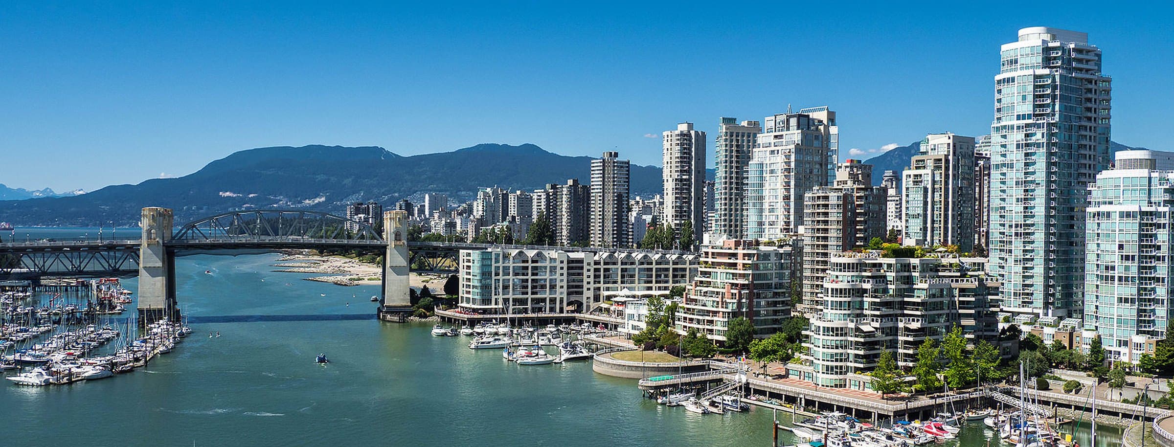 False Creek marina, Burrard Street Bridge, and Vancouver skyline with the North Shore Mountains beyond